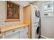 Bright laundry area features stacked washer/dryer and built in cabinets at 10535 Cottoneaster Way, Parker, CO 80134