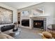 Bright living room showcasing a fireplace with decorative tiles and a large area rug at 10535 Cottoneaster Way, Parker, CO 80134