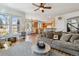 Cozy living room with an open layout, hardwood floors, and seamless connection to the kitchen and dining areas at 10535 Cottoneaster Way, Parker, CO 80134