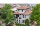 Aerial view of a three-story home with a Spanish-style roof, lush landscaping, and private balconies at 579 Madison St, Denver, CO 80206