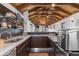 Entertaining space with custom bar featuring wood-beam ceilings at 579 Madison St, Denver, CO 80206