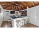 Entertaining space featuring wood-beam ceilings and a bar with barstool seating at 579 Madison St, Denver, CO 80206