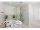 Bright bathroom featuring a standalone tub, glass enclosed shower, and marble tile at 579 Madison St, Denver, CO 80206