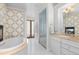 Elegant bathroom with a soaking tub, glass-enclosed shower, and a marble-topped vanity at 579 Madison St, Denver, CO 80206