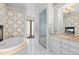 Elegant bathroom with double doors, glass enclosed shower and double sink vanity at 579 Madison St, Denver, CO 80206