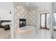 Bright bathroom features a soaking tub, fireplace, and access to the main bedroom at 579 Madison St, Denver, CO 80206