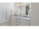 Elegant bathroom featuring double sinks, marble countertops, and a large, well-lit mirror at 579 Madison St, Denver, CO 80206