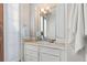 White bathroom vanity features marble countertop, faucet, and mirror with light fixture at 579 Madison St, Denver, CO 80206