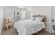 Bright bedroom featuring shuttered windows, a decorative chandelier, and a carved wood headboard at 579 Madison St, Denver, CO 80206