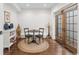 Cozy dining area with a round table, hardwood floors, and French doors, creating an inviting atmosphere at 579 Madison St, Denver, CO 80206