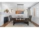 Formal dining room with a modern chandelier, fireplace, and classic wainscoting at 579 Madison St, Denver, CO 80206