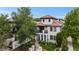 Stunning two-story home with a red tile roof, arched entry, balcony, and beautifully landscaped front yard at 579 Madison St, Denver, CO 80206