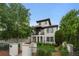 Charming three-story home boasts manicured landscaping, Spanish-style roof, and a private balcony at 579 Madison St, Denver, CO 80206