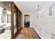 Bright hallway with hardwood floors, white cabinetry, and access to an outdoor patio at 579 Madison St, Denver, CO 80206