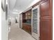 Finished basement hallway featuring cherry cabinets, a wine refrigerator, and a full-sized refrigerator, great for entertaining at 579 Madison St, Denver, CO 80206