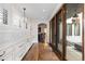 Bright hallway with hardwood floors, white cabinetry, and access to an outdoor patio at 579 Madison St, Denver, CO 80206