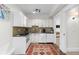 Well-lit kitchen with white cabinetry, modern appliances, and a tile backsplash, offering a clean and functional space at 579 Madison St, Denver, CO 80206