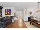 Open living area with hardwood floors, fireplace, bar with seating, and staircase access at 579 Madison St, Denver, CO 80206