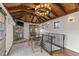 Cozy living room with wood-beamed vaulted ceiling, fireplace, and stylish light fixtures at 579 Madison St, Denver, CO 80206