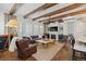 Inviting living room featuring wood beams, hardwood floors, and a cozy fireplace at 579 Madison St, Denver, CO 80206