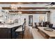 Open-concept living space showcasing a kitchen island, wood beams, and an inviting seating area at 579 Madison St, Denver, CO 80206