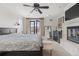 Main bedroom featuring a ceiling fan, a fireplace, balcony access, and a neutral color palette at 579 Madison St, Denver, CO 80206
