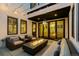 Covered patio with a modern fire pit, ample seating, and views of the house interior at 579 Madison St, Denver, CO 80206