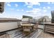 Relaxing rooftop patio with modern furniture, glass railings, and blue skies at 579 Madison St, Denver, CO 80206