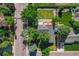 Aerial view of a home with a large yard, mature trees, and a detached garage at 7120 S Sheridan Ct, Littleton, CO 80128