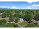 Residential area with a single Gathering home with a well-manicured lawn and mature trees at 7120 S Sheridan Ct, Littleton, CO 80128