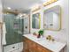 Stylish bathroom featuring a double sink vanity, shower with glass door, and modern fixtures at 7120 S Sheridan Ct, Littleton, CO 80128