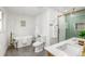 Elegant bathroom with a soaking tub, double sink vanity, and glass shower at 7120 S Sheridan Ct, Littleton, CO 80128
