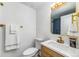 Stylish bathroom featuring blue tile and a white vanity with modern gold fixtures at 7120 S Sheridan Ct, Littleton, CO 80128