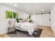 Bright bedroom featuring wood floors, a modern rug, and lots of natural light at 7120 S Sheridan Ct, Littleton, CO 80128
