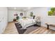 Bright bedroom with a modern rug, wood floors, and big windows at 7120 S Sheridan Ct, Littleton, CO 80128