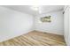 Bright, empty bedroom with wood floors and a large window at 7120 S Sheridan Ct, Littleton, CO 80128