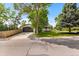 Attractive home features a spacious driveway, two-car garage, well-maintained lawn, and mature trees at 7120 S Sheridan Ct, Littleton, CO 80128