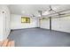 This spacious garage has light gray flooring, white walls, a window, and two garage doors at 7120 S Sheridan Ct, Littleton, CO 80128