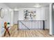 Bright hallway features modern decor, wood floors, and access to multiple rooms in the home at 7120 S Sheridan Ct, Littleton, CO 80128