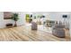 Open-concept living room featuring wood floors, comfortable seating, and access to an outdoor deck at 7120 S Sheridan Ct, Littleton, CO 80128