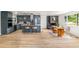 Open floor plan with a kitchen, dining area, fireplace, and wood flooring throughout the living space at 7120 S Sheridan Ct, Littleton, CO 80128