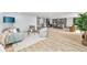 Inviting open living space showcasing wood floors, an updated kitchen, dining area, and stylish furniture at 7120 S Sheridan Ct, Littleton, CO 80128