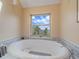 Relaxing bathroom featuring a soaking tub under a large window with stunning mountain views, perfect for unwinding at 13288 Elsie Rd, Conifer, CO 80433