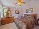 Traditional bedroom showcasing a wooden dresser and bedframe, complemented by warm-toned bedding and ambient lighting at 13288 Elsie Rd, Conifer, CO 80433