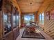 Charming dining room featuring wood-paneled walls and ceilings with scenic views from its large picture window at 13288 Elsie Rd, Conifer, CO 80433