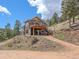 Charming home featuring an expansive outdoor deck perfect for entertaining and mountain views at 13288 Elsie Rd, Conifer, CO 80433