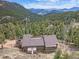 Stunning mountain home with a spacious deck, surrounded by lush greenery and scenic views at 13288 Elsie Rd, Conifer, CO 80433