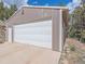 Spacious two-car garage with a white door, offering ample storage and parking at 13288 Elsie Rd, Conifer, CO 80433