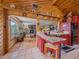 Warm kitchen with wooden accents, granite countertops, and an adjacent living space for easy entertaining at 13288 Elsie Rd, Conifer, CO 80433