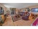 Cozy living room features a stone fireplace, hardwood floors, and a comfortable seating arrangement at 13288 Elsie Rd, Conifer, CO 80433